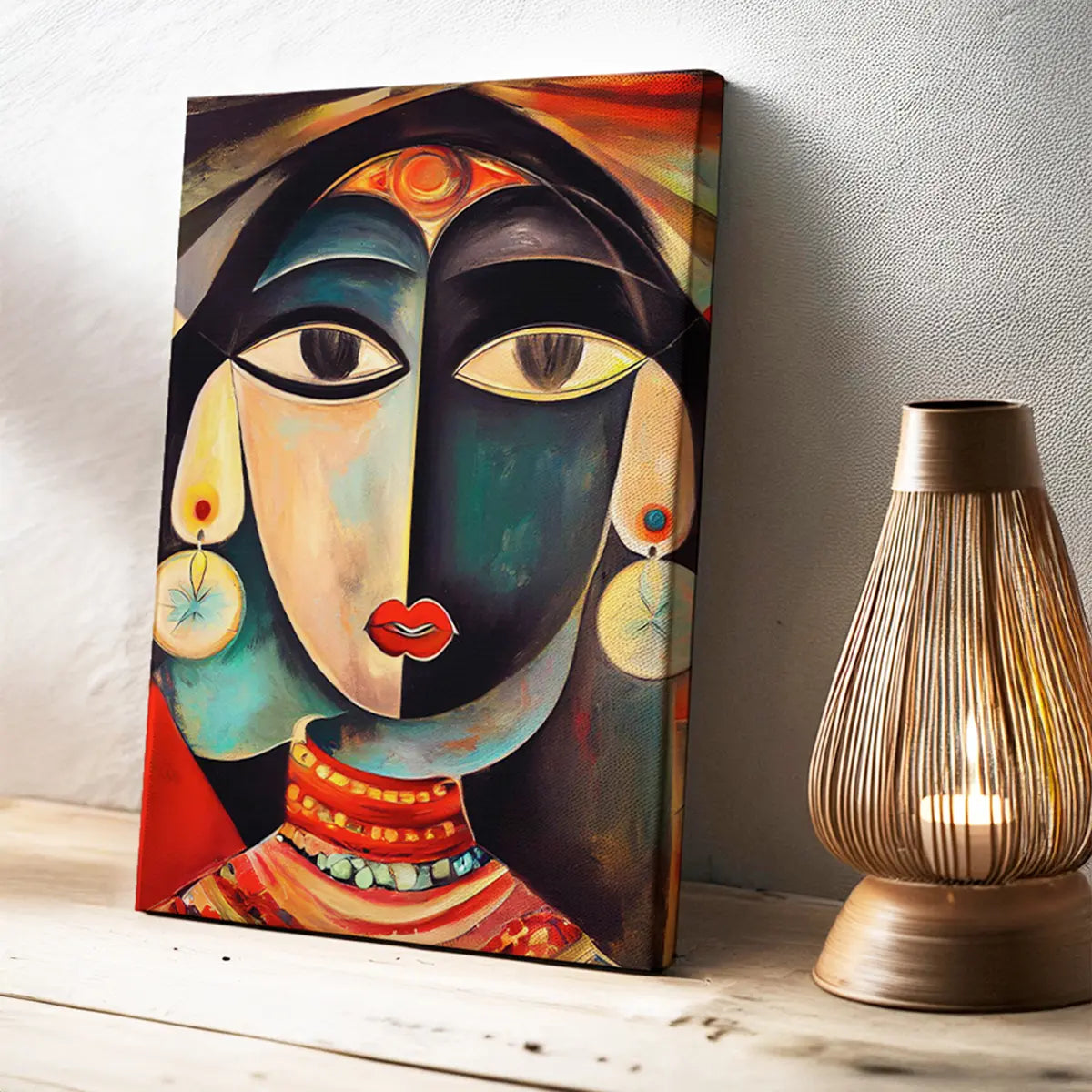 Abstract art painting of a face on a wall next to a decorative lamp. Black and blue color, Picasso style modern abstract Indian woman canvas wall art painting, framed canvas art prints for modern living room, home wall art decor.