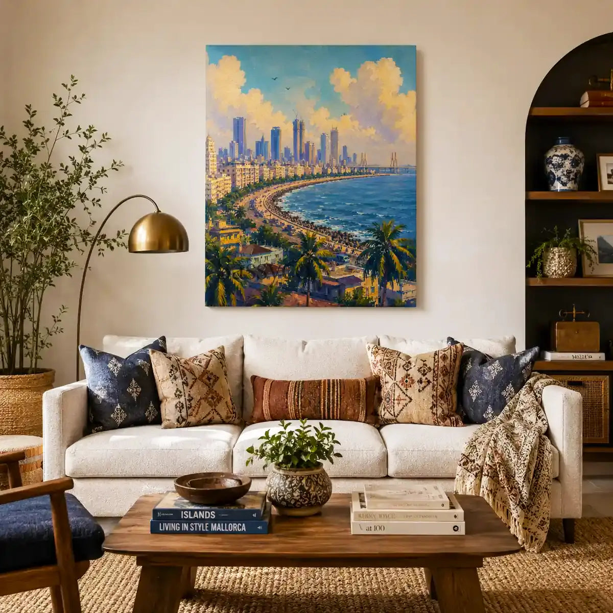 A blue, white and green Mumbai India Marine Drive Queen's Necklace cityscape with the curving seafront promenade, palm trees, Bandra-Worli Sea Link and skyline under sunlit clouds wall art painting, as a gallery wrap framed canvas print styled hanging on a wall behind a couch sofa in a modern living room- Mumbai cityscape canvas wall art, India skyline wall art, Marine Drive poster artwork print for living room, bedroom and home office wall decor.