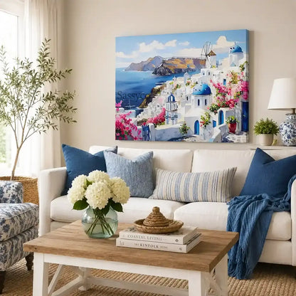 Santorini Greece Oia village cityscape with whitewashed homes, blue-domed churches, a windmill and bougainvillea over the Aegean Sea painting, styled in a living room - Greece island travel wall art, Mediterranean coastal canvas wall art, Santorini poster artwork print for living room, bedroom and home office wall decor