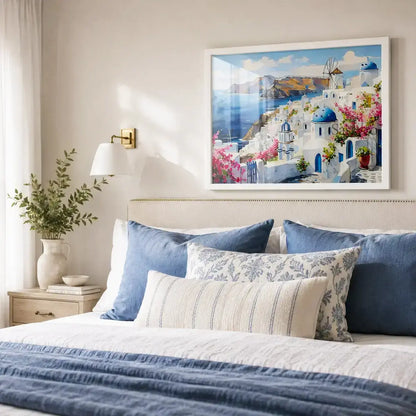 Santorini Greece Oia village cityscape with whitewashed homes, blue-domed churches, a windmill and bougainvillea over the Aegean Sea painting wall art hanging in a bedroom on the wall behind the bed  - Greece island travel wall art, Mediterranean coastal canvas wall art, Santorini poster artwork print for living room, bedroom and home office wall decor