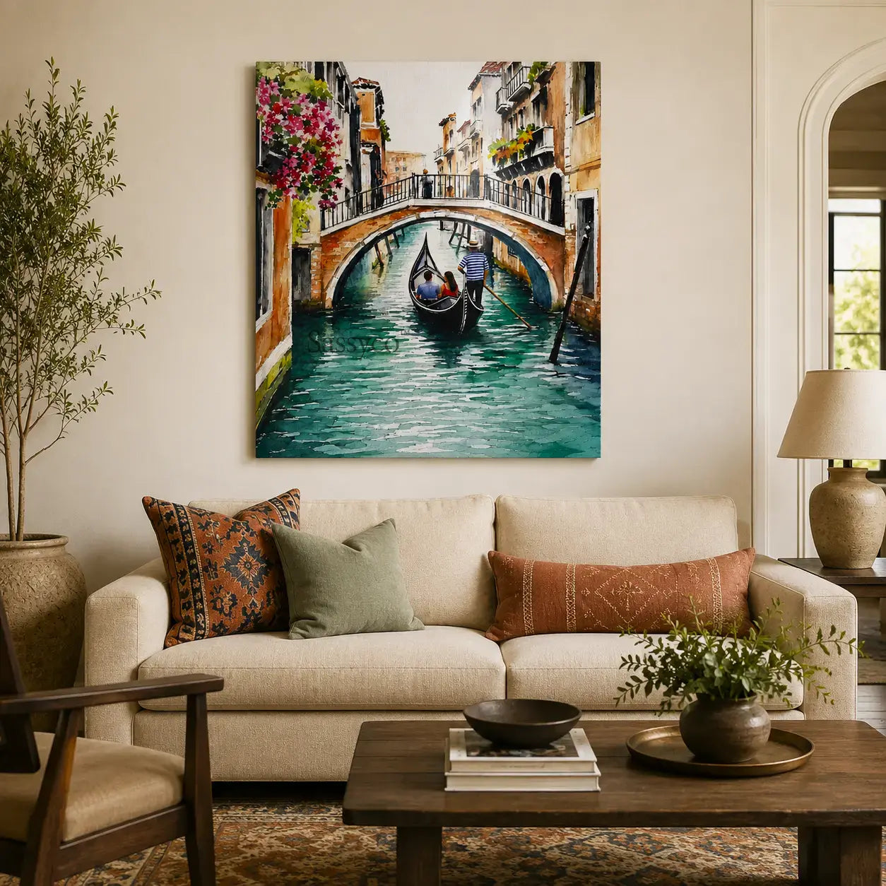 Venice Italy gondola canal cityscape with a gondolier rowing beneath a bougainvillea-draped stone bridge watercolor painting, styled hanging on wall behind a sofa couch in a living room - Italy travel wall art, Europe cityscape canvas wall art, Venice poster artwork print for living room, bedroom and home office wall decor